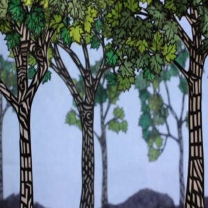 Detail of Abigail Baird hand-cut paper forest with patterned trunks and layered green leaves